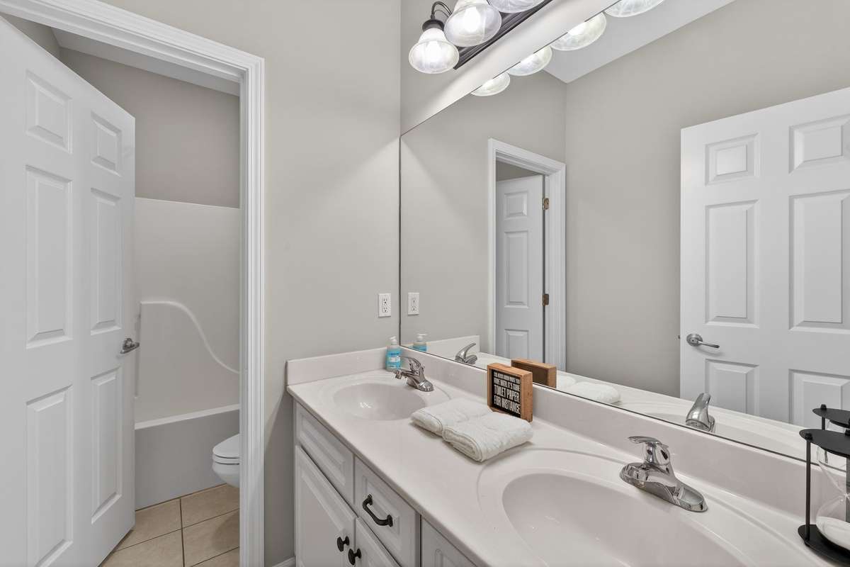 Second full bathroom with double sinks and separate room for shower.