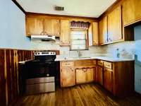 Kitchen does have granite and cedar wainscotting.