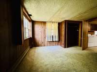 Another view of basement bedroom with windows and closet.