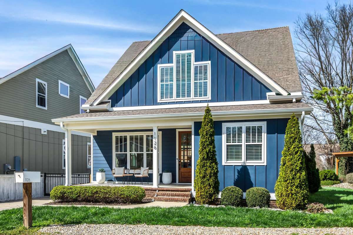 Charming exterior with covered front porch, manicured landscaping, and inviting entry. Walkable to downtown Franklin!
