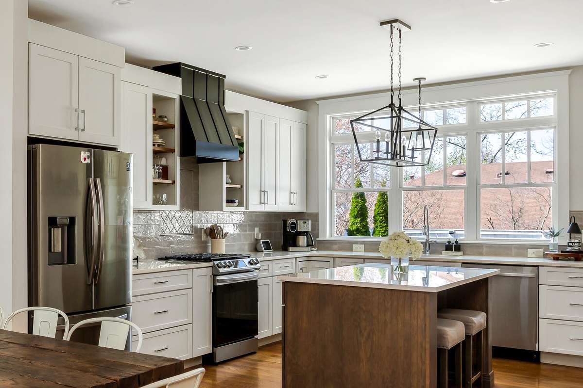 Timeless design with white cabinetry, a spacious island, and stainless steel appliances.