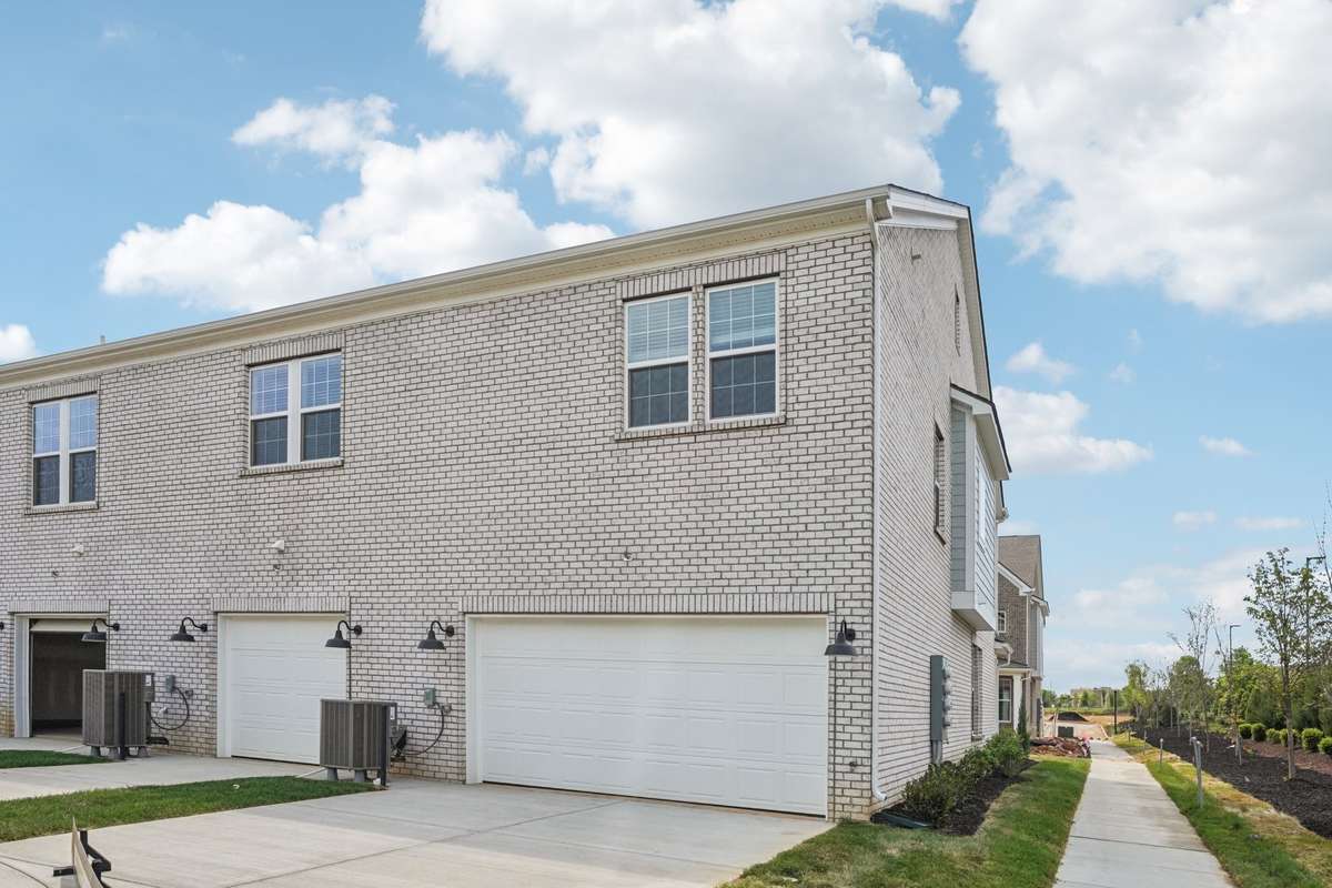 This corner unit "Paseo" includes a 2-car garage with two additional driveway spaces. Enjoy peaceful views of the greenery along the side of the building!