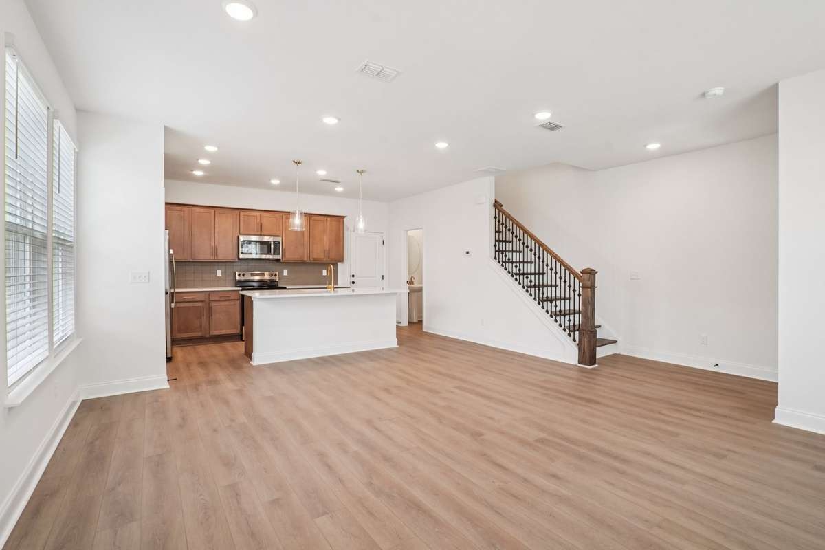 Luxury vinyl plank (LVP) flooring is included throughout the 1st floor, along with hardwood stairs leading to the 2nd floor.