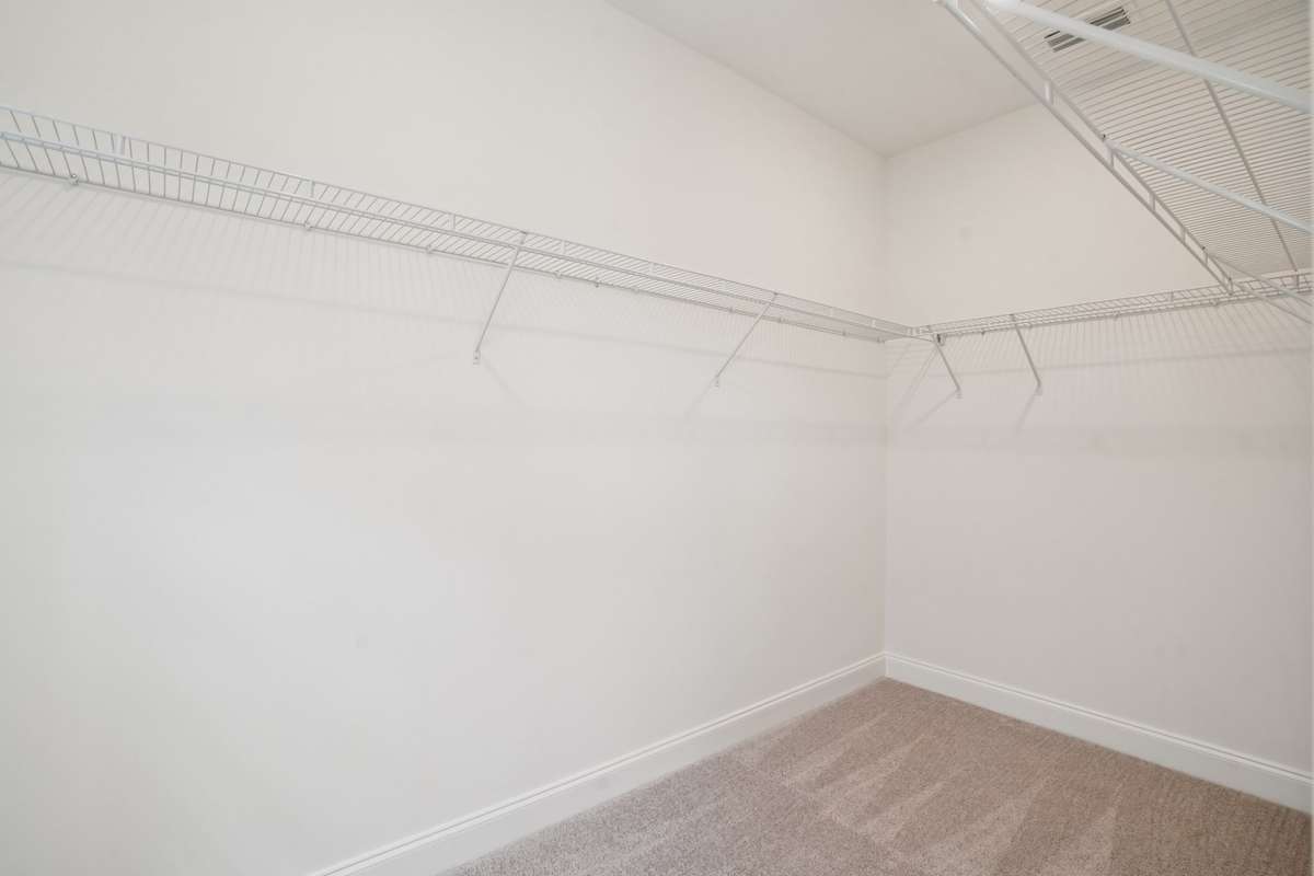 The primary suite features a roomy walk-in closet, perfect for keeping your wardrobe organized.