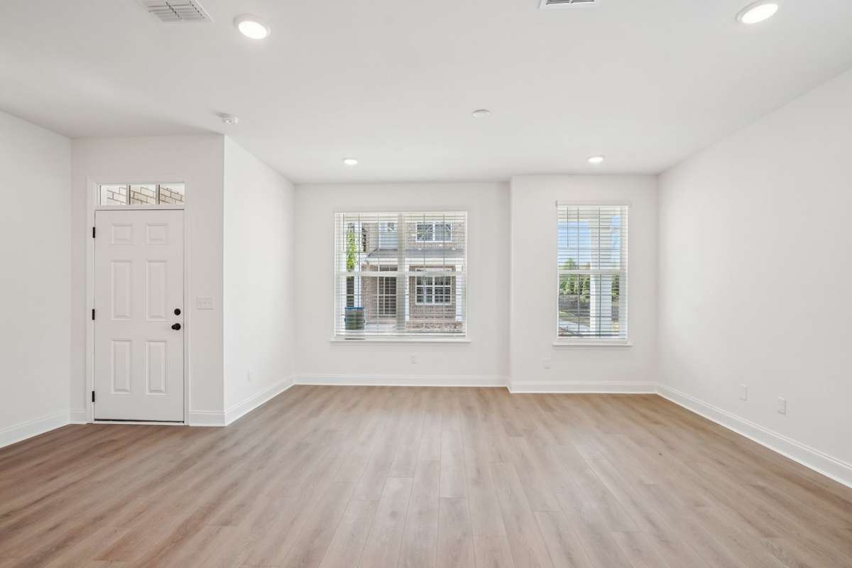 Expansive windows floor this end-unit townhouse with abundant natural light, creating a bright and welcoming living space.