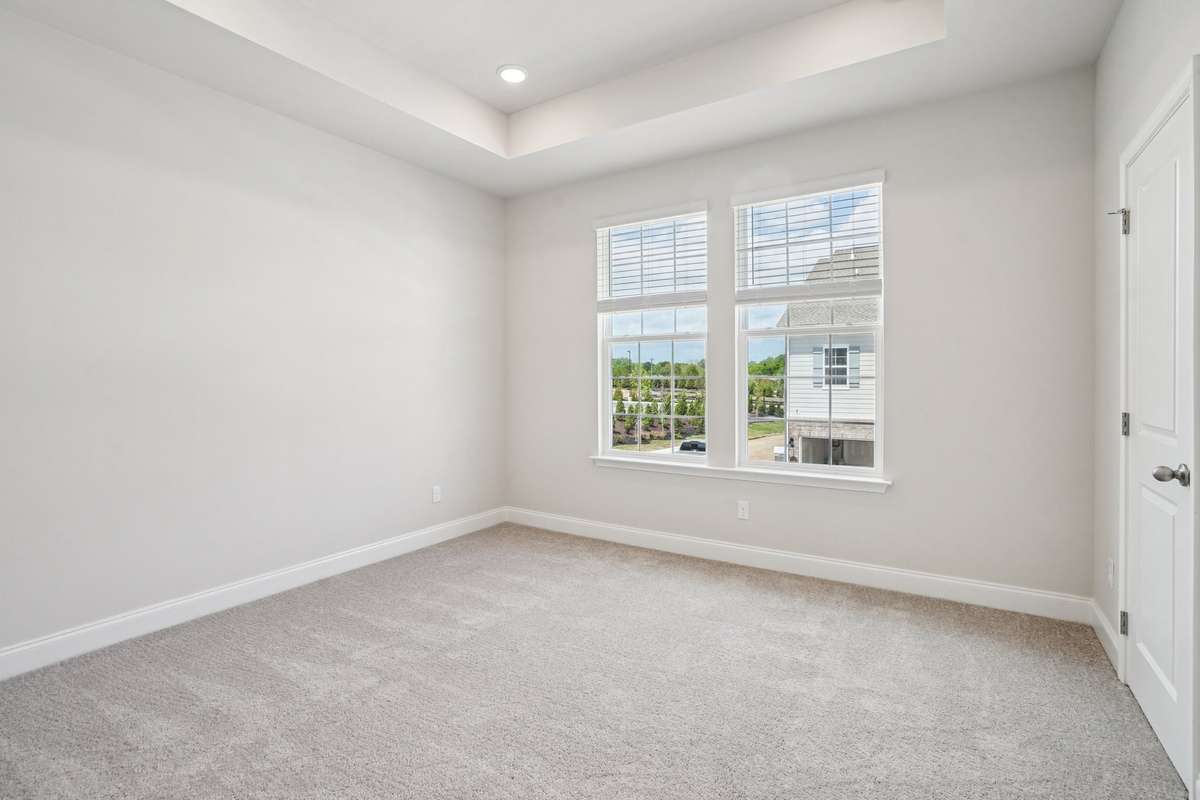 The primary bedroom is privately situated upstairs, just off the main living area, offering a peaceful retreat away from the home’s central gathering spaces. Spacious and comfortable, it provides an ideal setting to unwind at the end of the day.