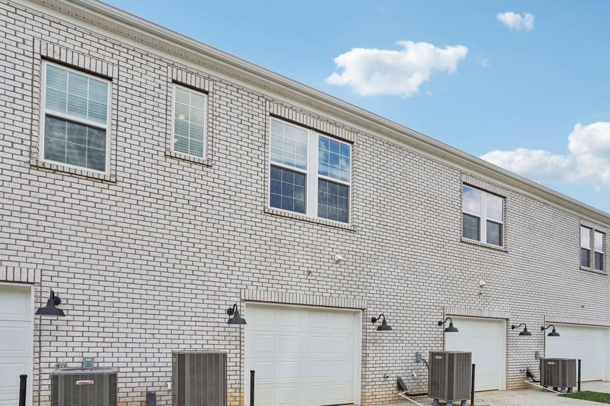An oversized one-car garage with extra storage space and a dedicated driveway spot adds convenience and practicality.