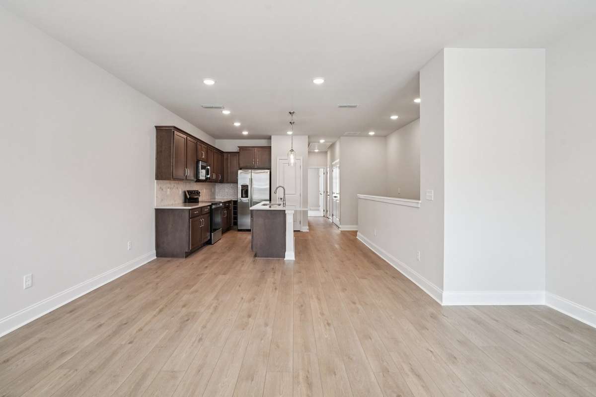 The Great Room offers generous space for versatile furniture arrangements, allowing you to create a comfortable and functional living area that flows seamlessly into the dining and kitchen spaces—perfect for both everyday living and entertaining.