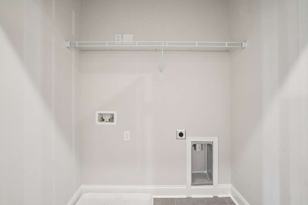 Your laundry space is conveniently located upstairs and features durable tile flooring, combining functionality with easy maintenance.