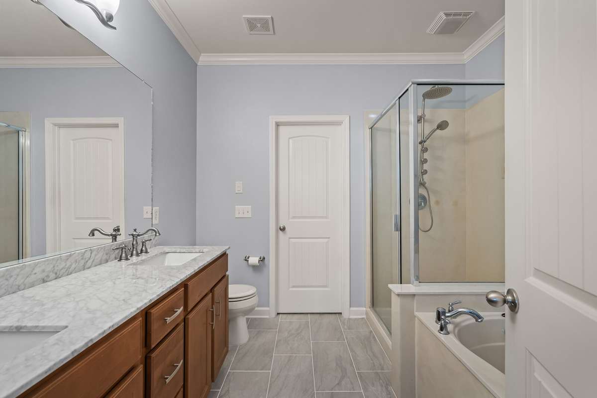 Primary bathroom with dual sinks and separate shower and tub