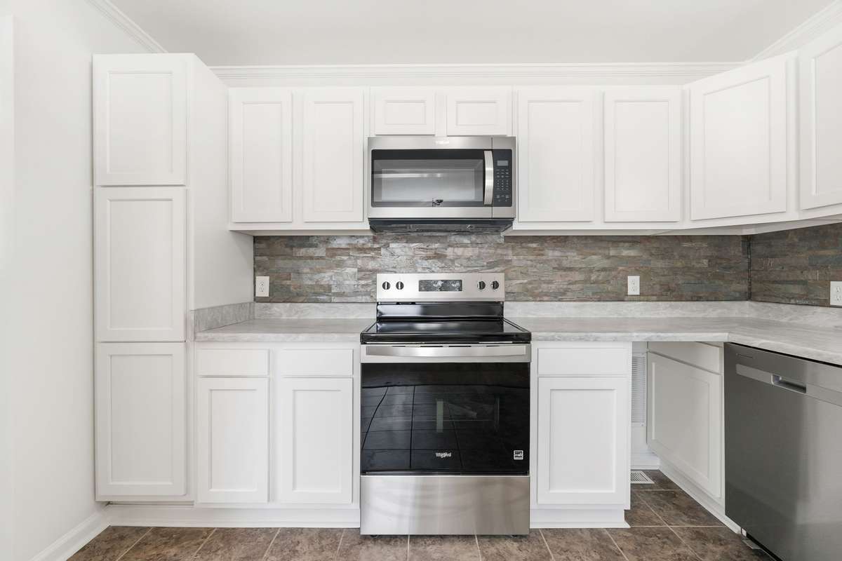 Nice pantry cabinet on the left side of the stove.