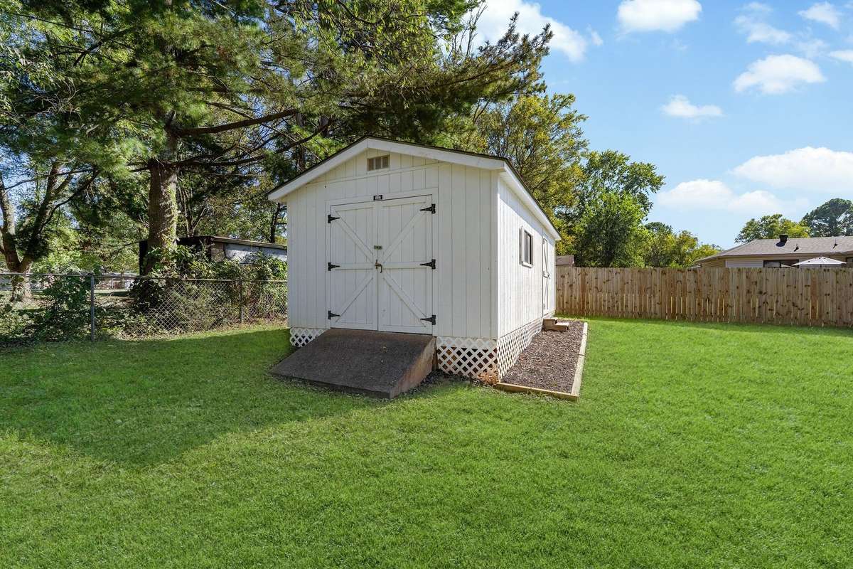 Large shed/workshop is newer and stays.