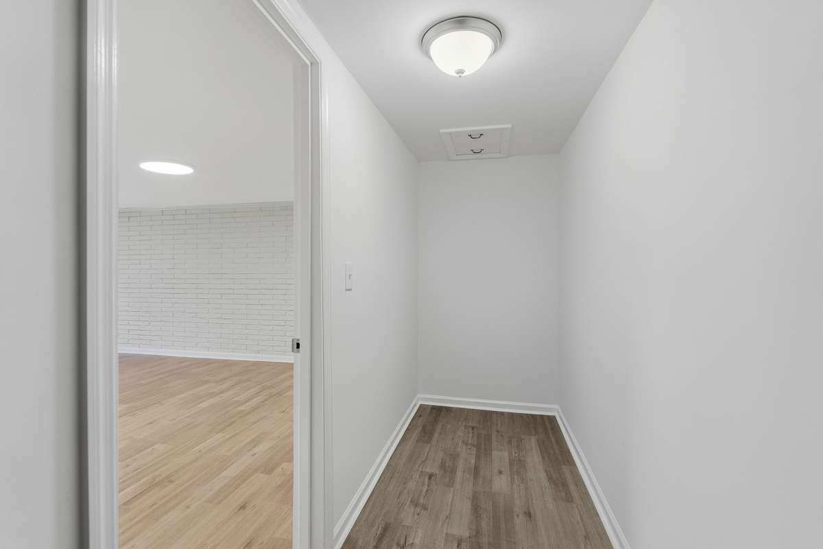 The closet floor matches the rest of the downstairs flooring.  The lighting in this photo just makes it look darker.