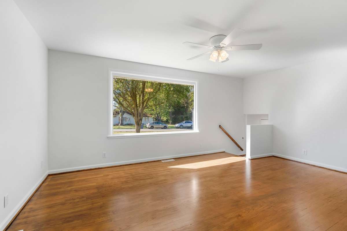 Up to the 2nd/middle level is the living room with a huge picture window binging in tons of natural light.  Original hardwood floors have been refinished.
