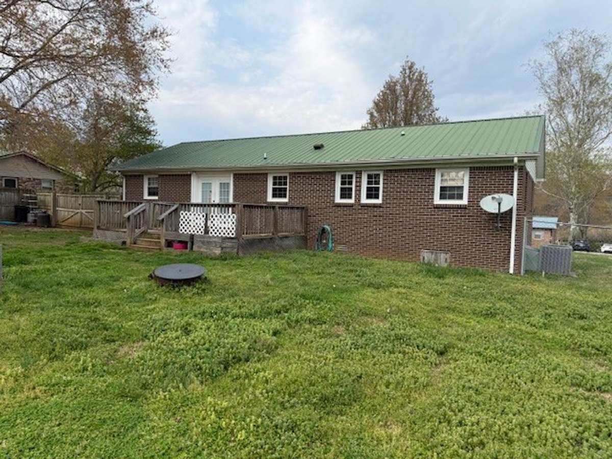 Rear view of the property.  The backyard is fenced in.