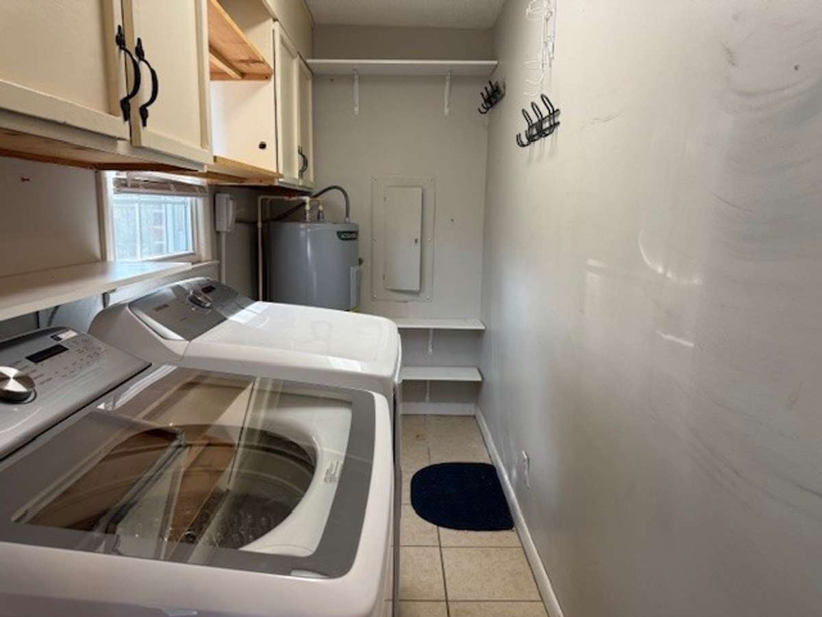 The laundry room has loads of storage.