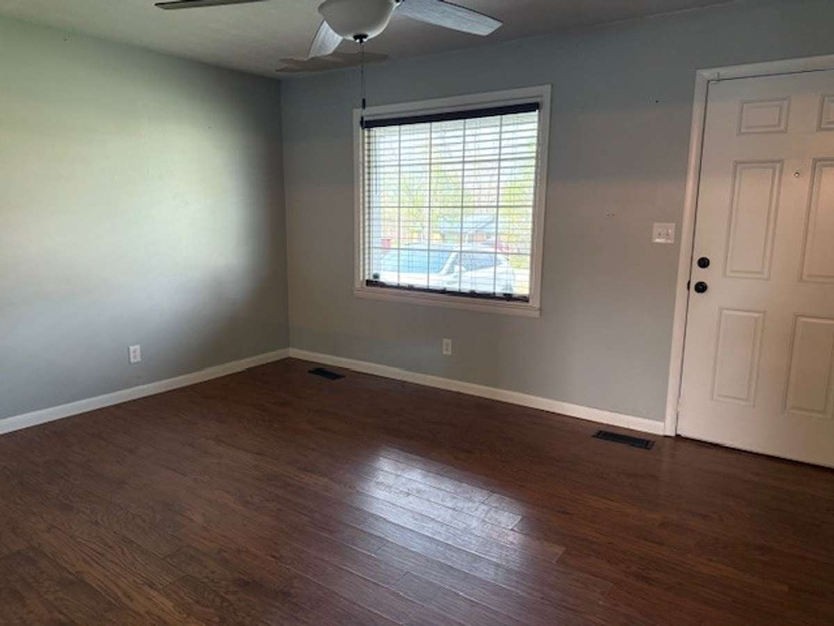 The large window in the living room provides natural light.