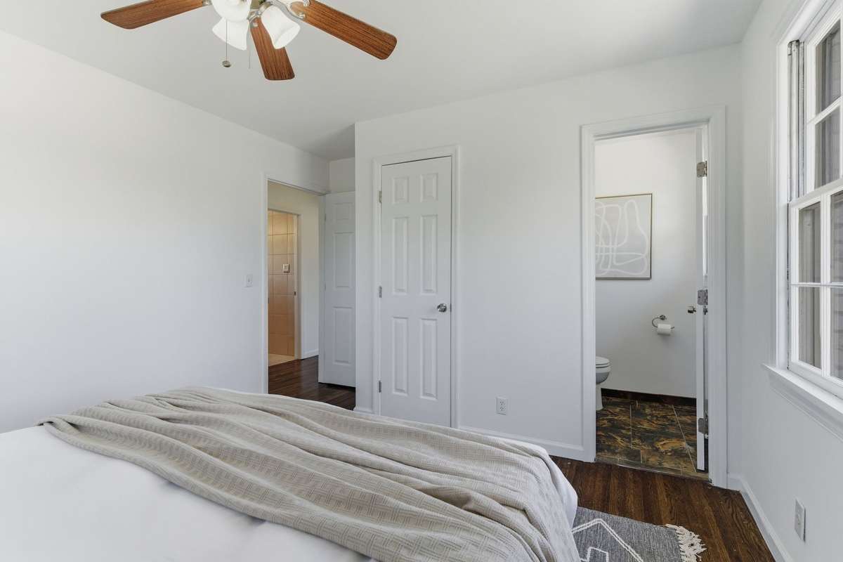 Primary bedroom with wonderful classic windows. Good morning sunshine!