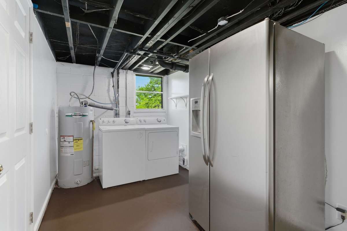 Downstairs flex space has easy access to washer and dryer and refrigerator - all remain.