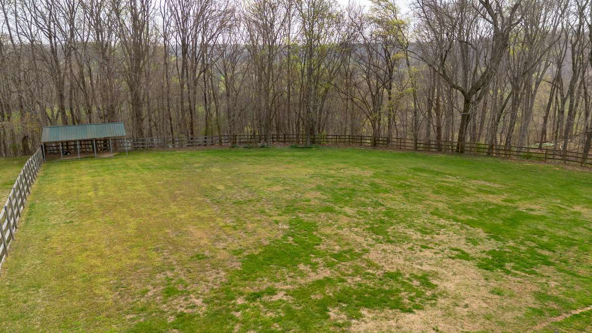 Fenced in back lawn. Freestanding canopy conveys with the property