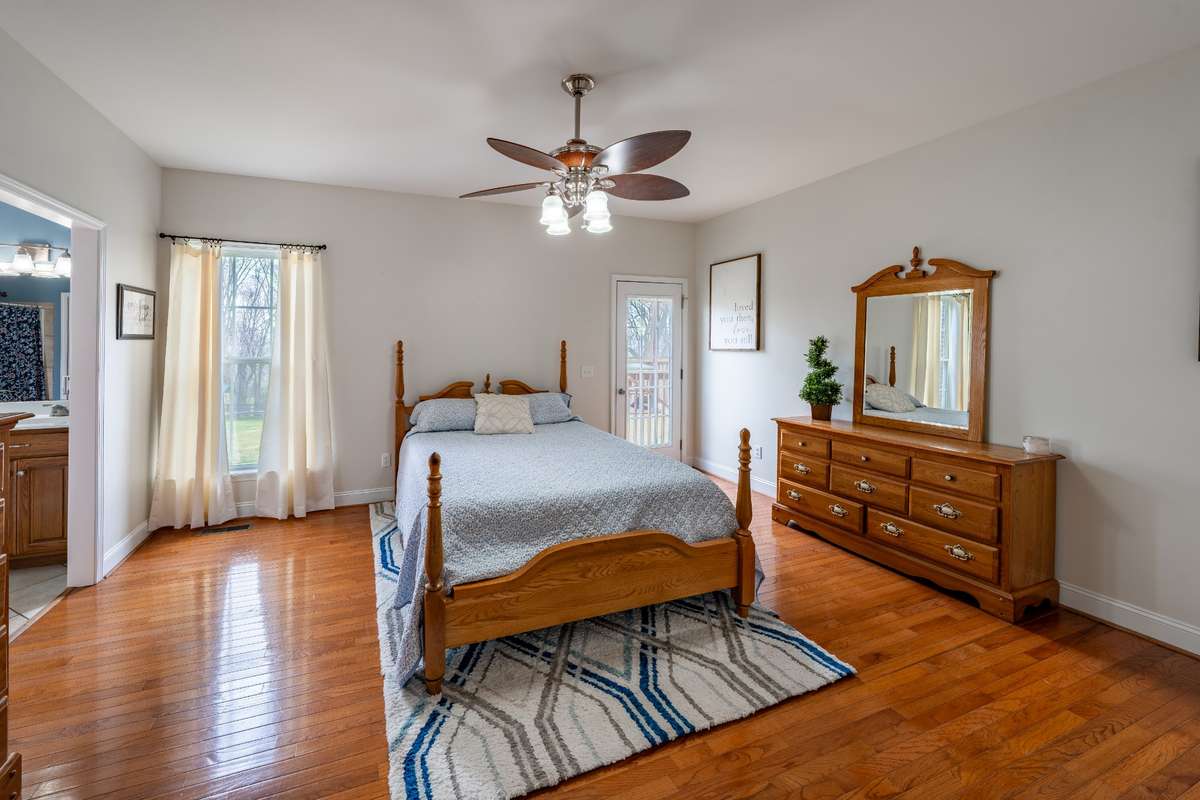 Primary bedroom with exit to covered deck