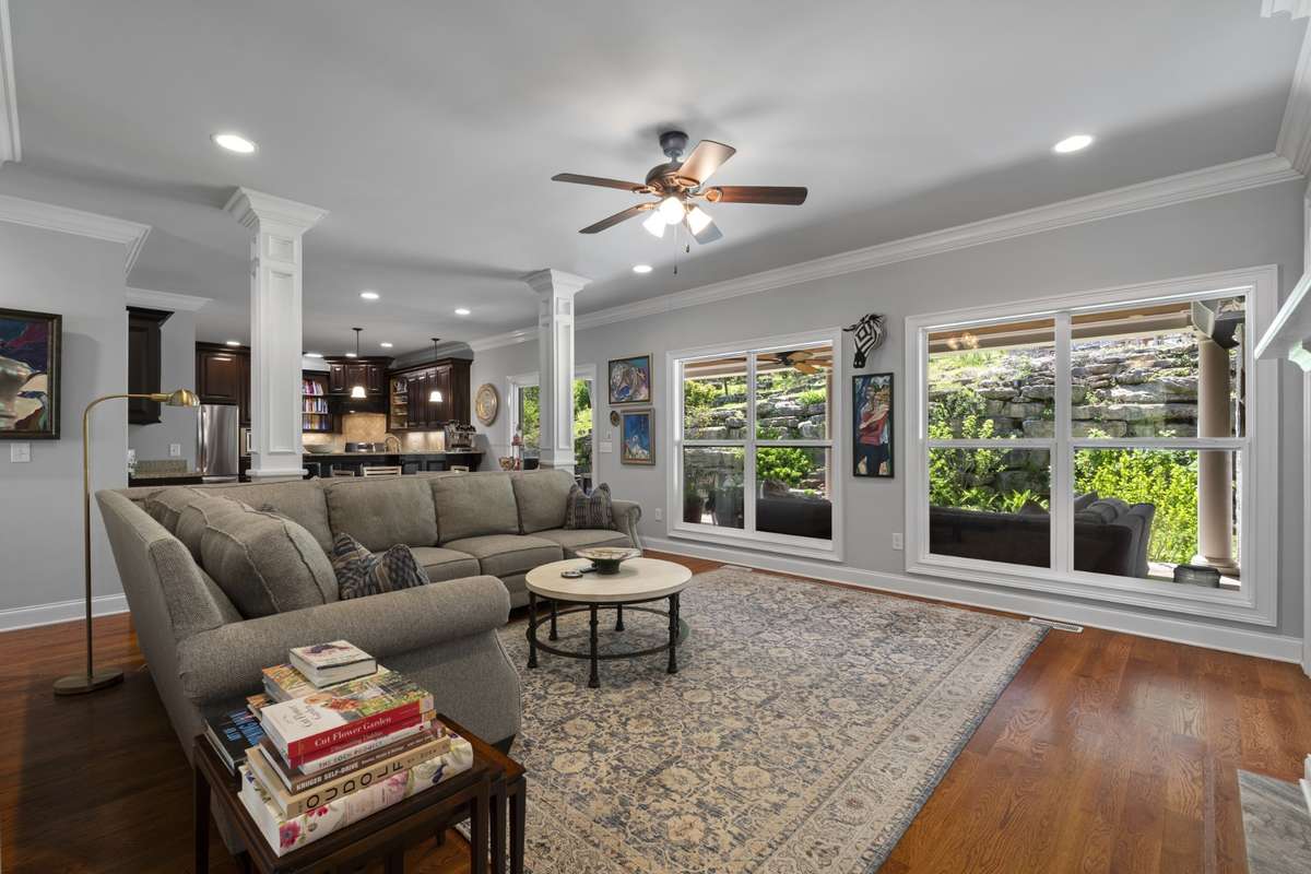 Living room features a wall of windows that look out to the spectacular backyard.