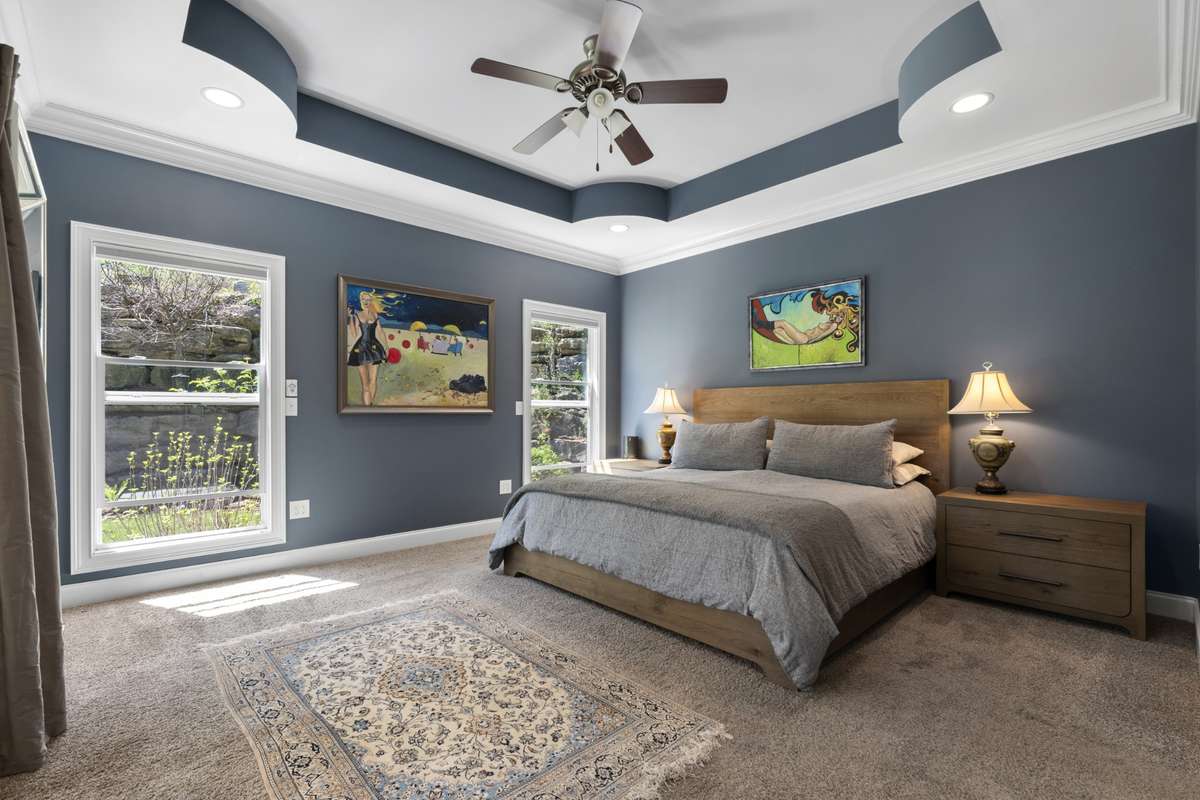 Primary suite is on main level features a frayed ceiling and sliding door access to back covered porch.