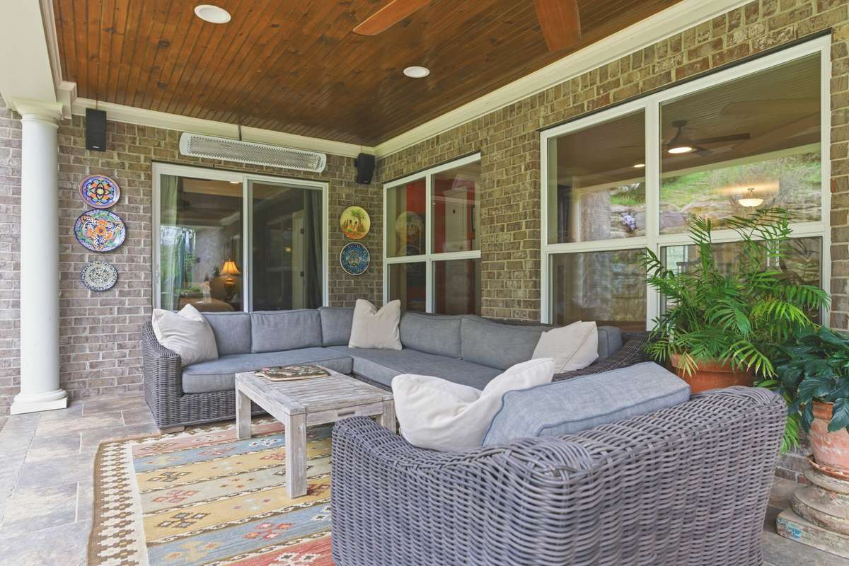 This covered back porch is amazing! Beadboard filing, a fam and enough space for lounging and dining!