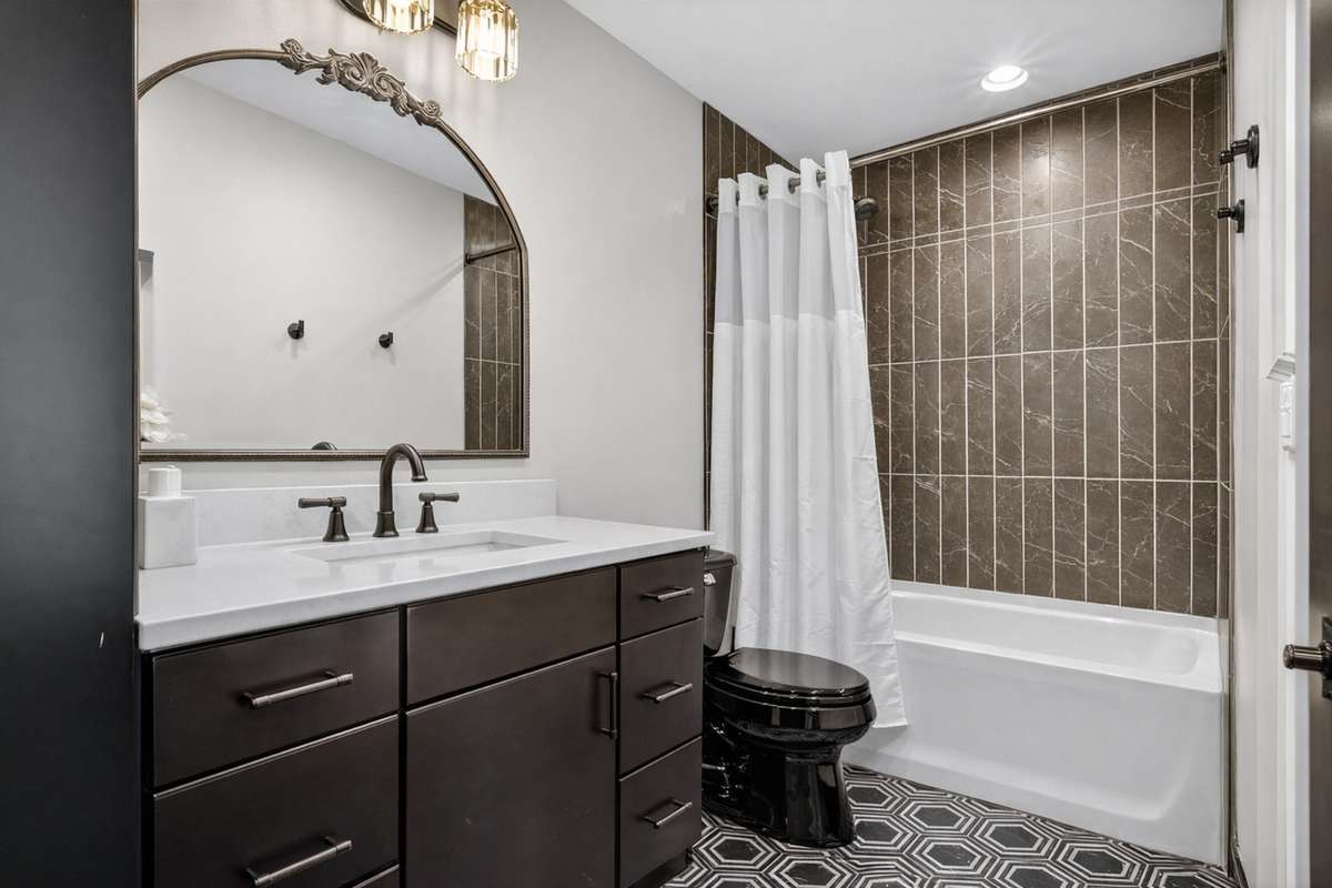 Fourth bedroom on the second level offers a private en-suite bathroom, providing comfort and convenience for guests or family.