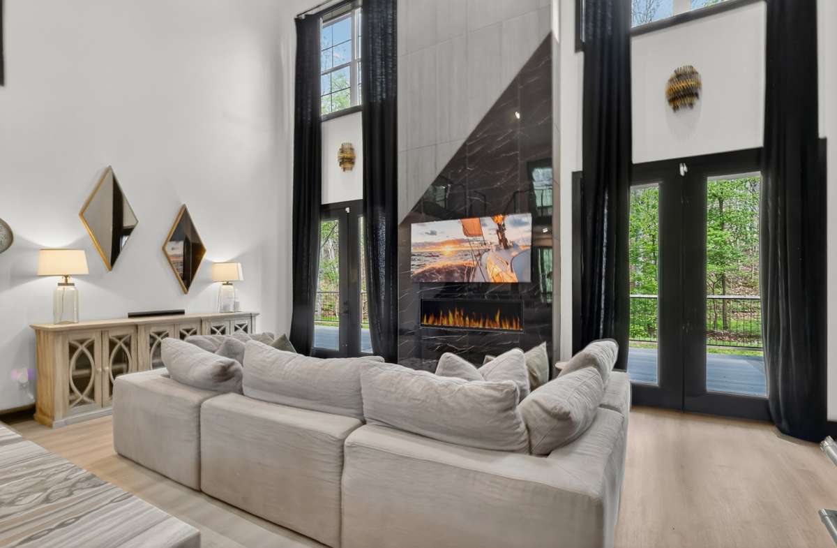 The living room features soaring ceilings that enhance natural light and spaciousness.