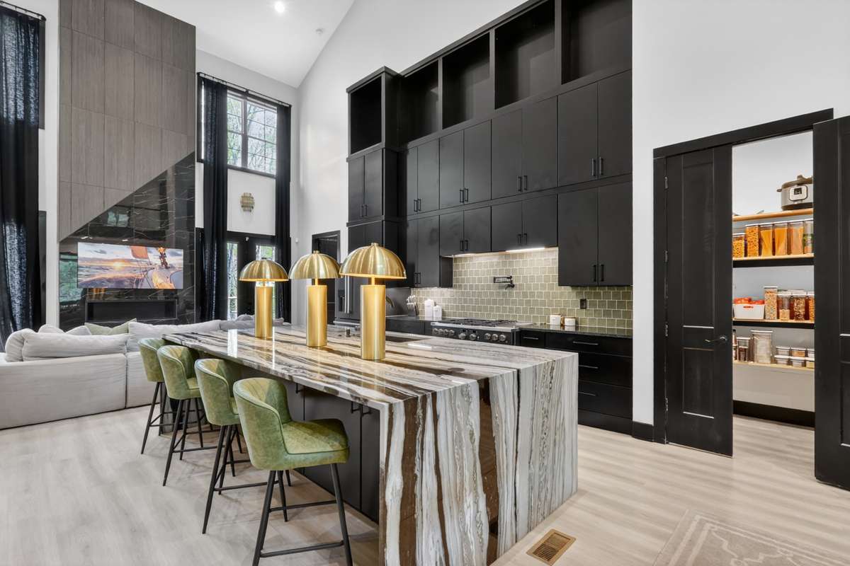 Soaring cabinetry with open storage, thoughtfully designed with space for a rolling ladder