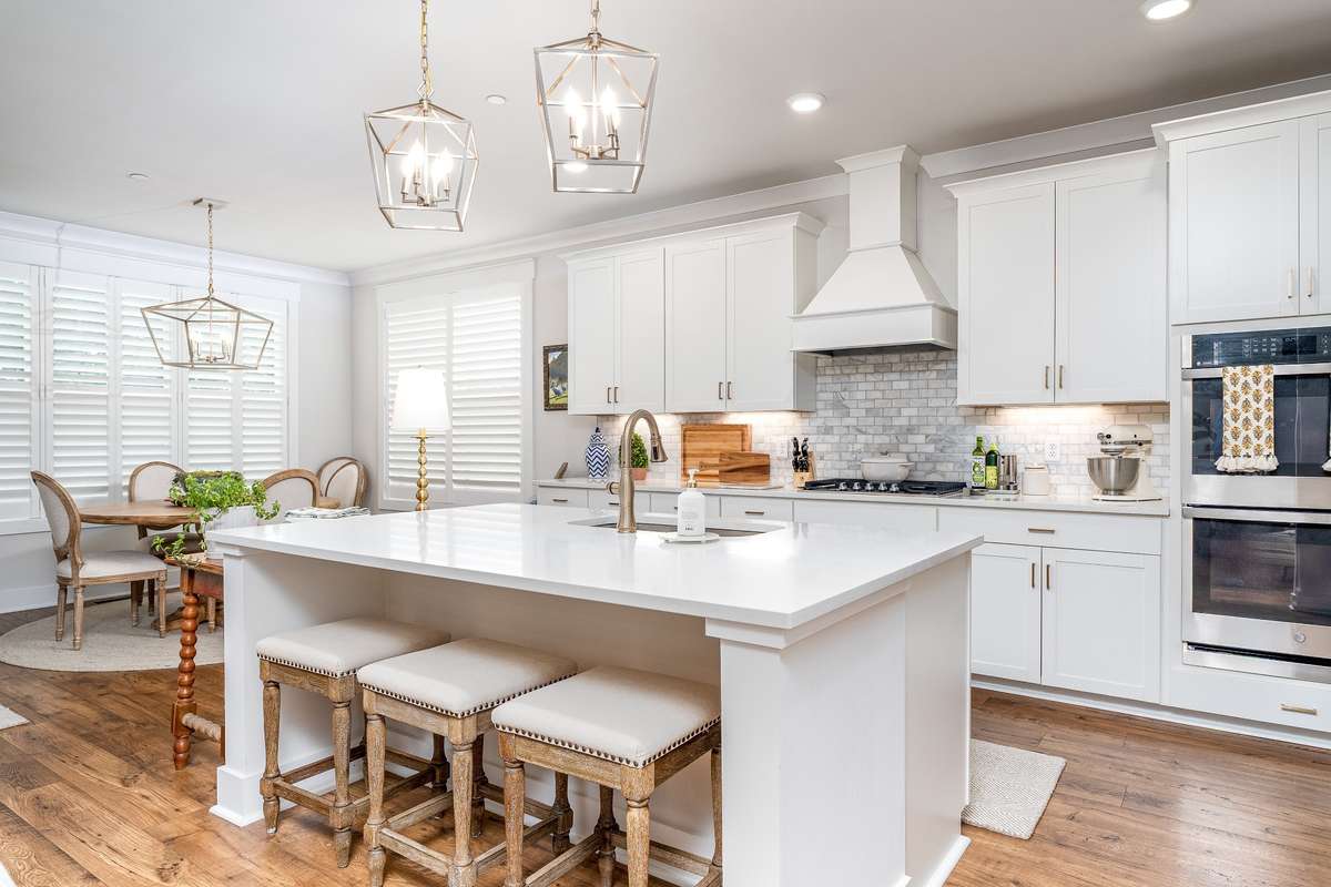 Kitchen features Oversized sit down Island featuring Granite Countertops, Gas Stovetop