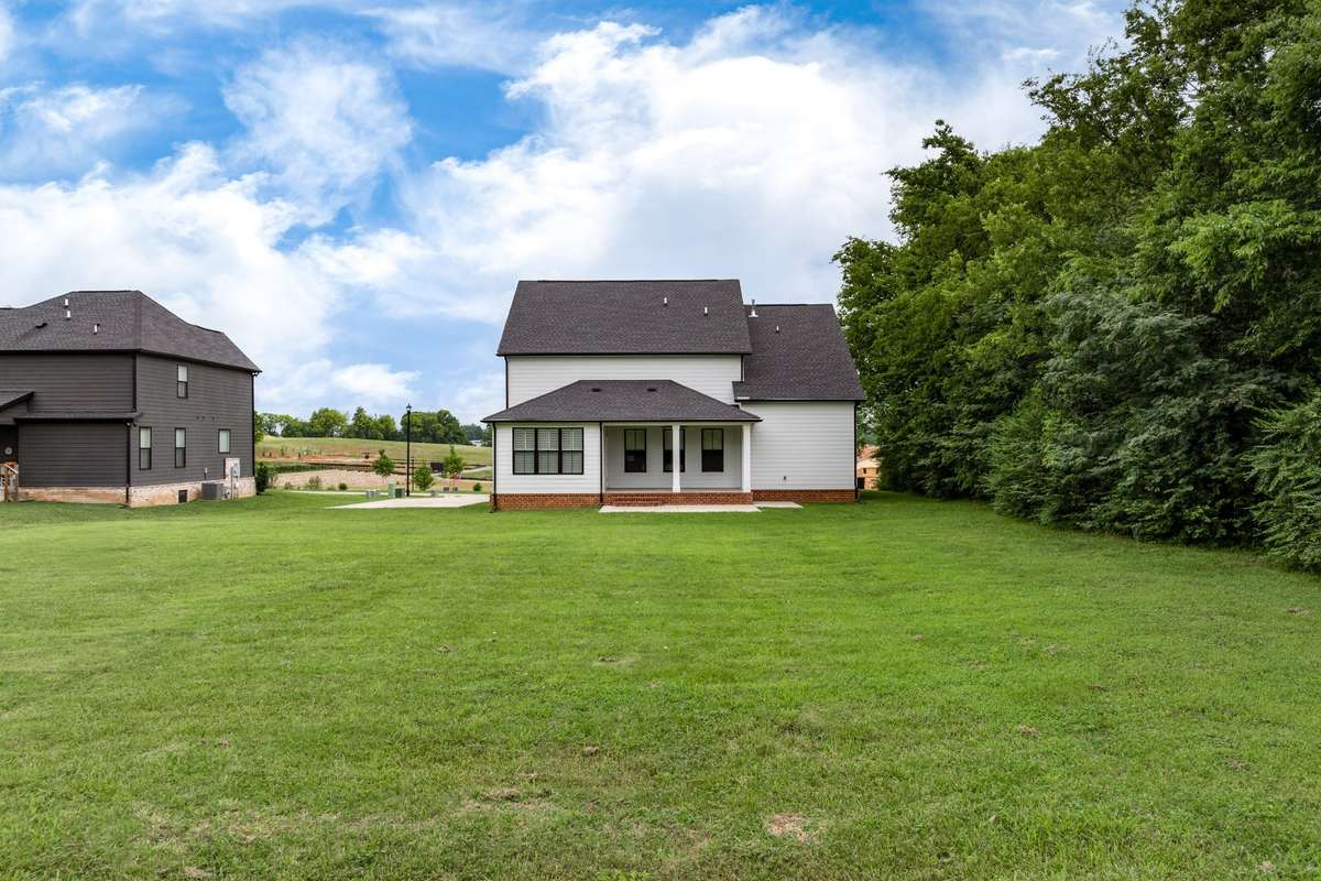 Large, level back yard and treelined in the back and one side
