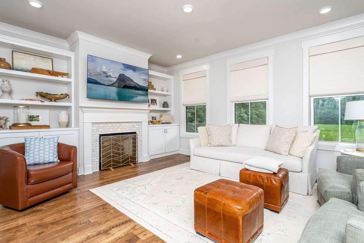 The family room - fireplace with auto start gas logs and custom cabinets on each side. An abundant of windows allows all the natural light to flow inside- Custom Blinds stay