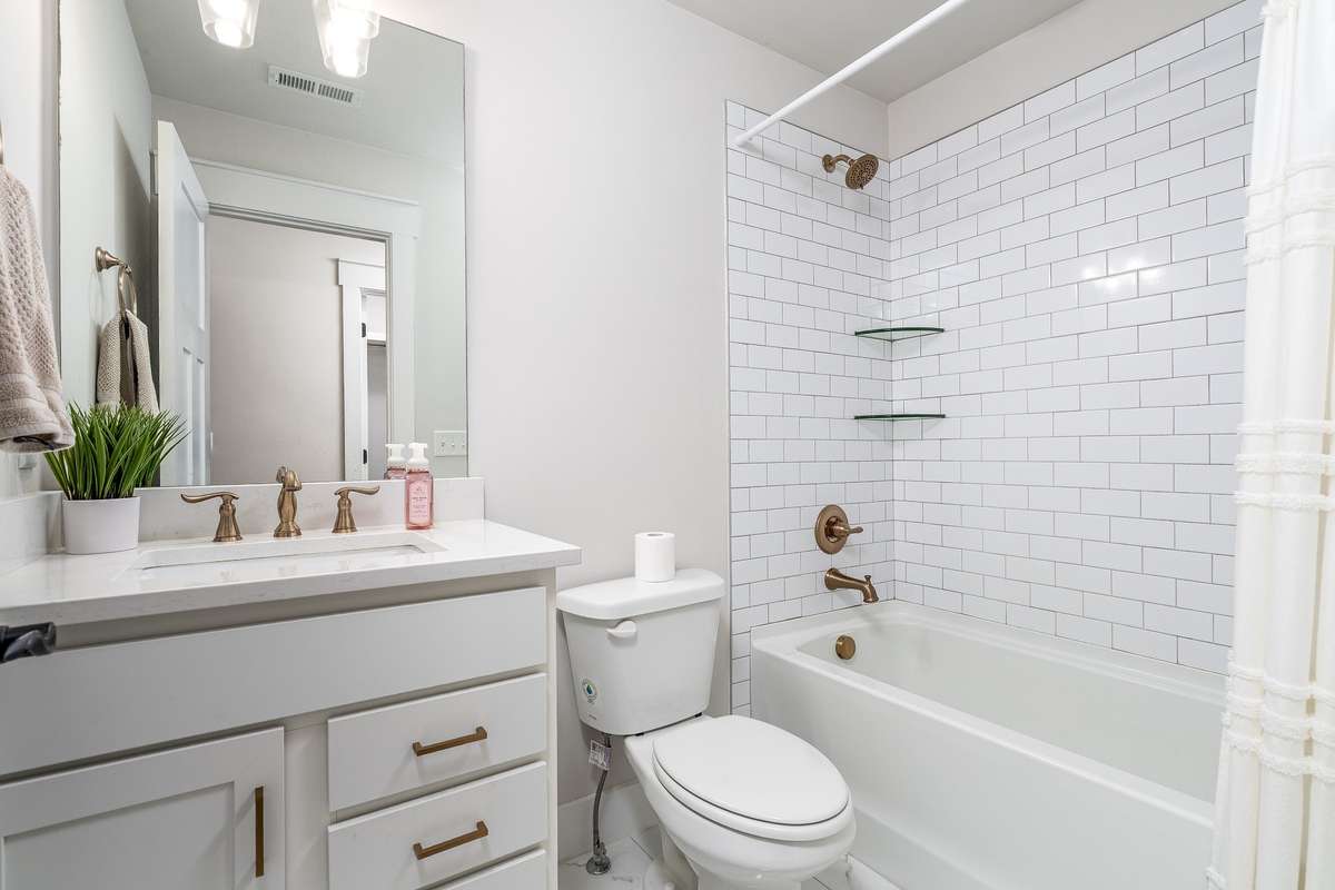Full Tiled shower/tub combo with Granite countertop - located in Bedroom #2