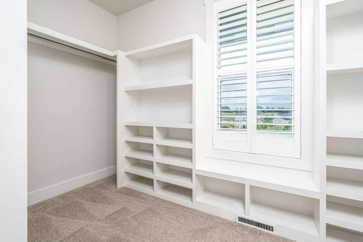 Primary Walk in closet with built in shelving