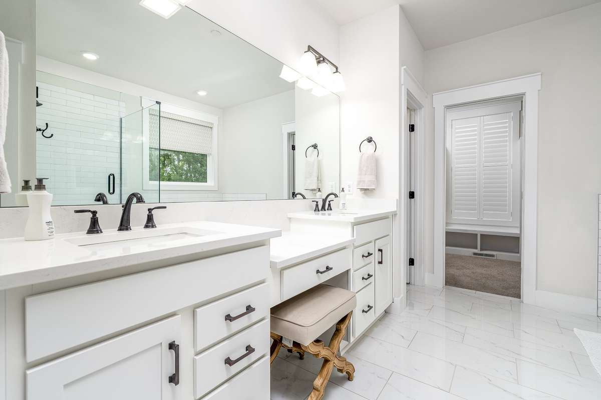 Primary Bathroom with Tiled floors, Granite counter top, make up area and double sinks