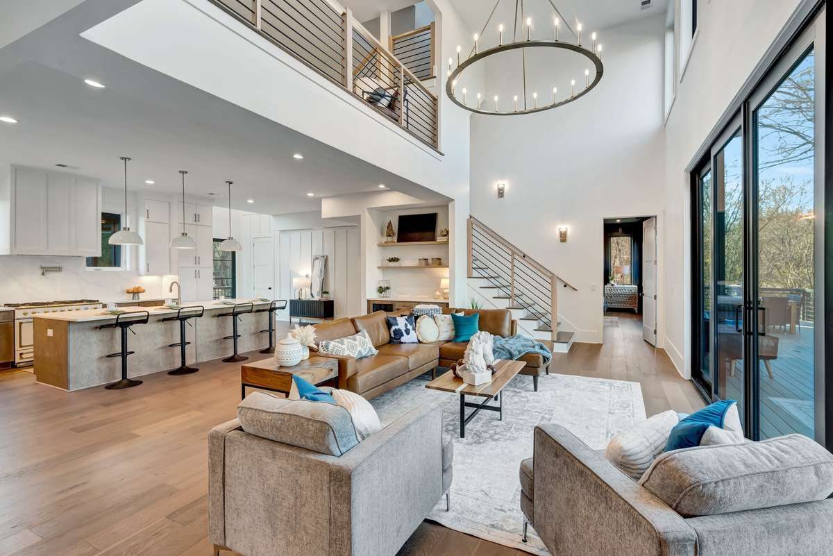 Soaring Ceilings and Walls of Glass Create a Stunning Setting in the Heart of Your Home plus Expansive Views of Your Private Backyard Oasis to the Harpeth River Banks and Beyond