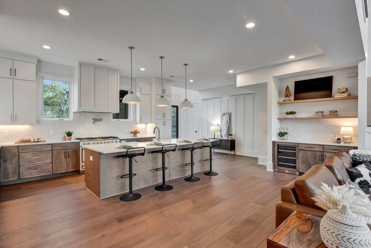 The oversized Island provides ample seating as well as workspace the Entertainment Bar offers a spot to welcome guest with a glass of wine from the built in Wine Fridge