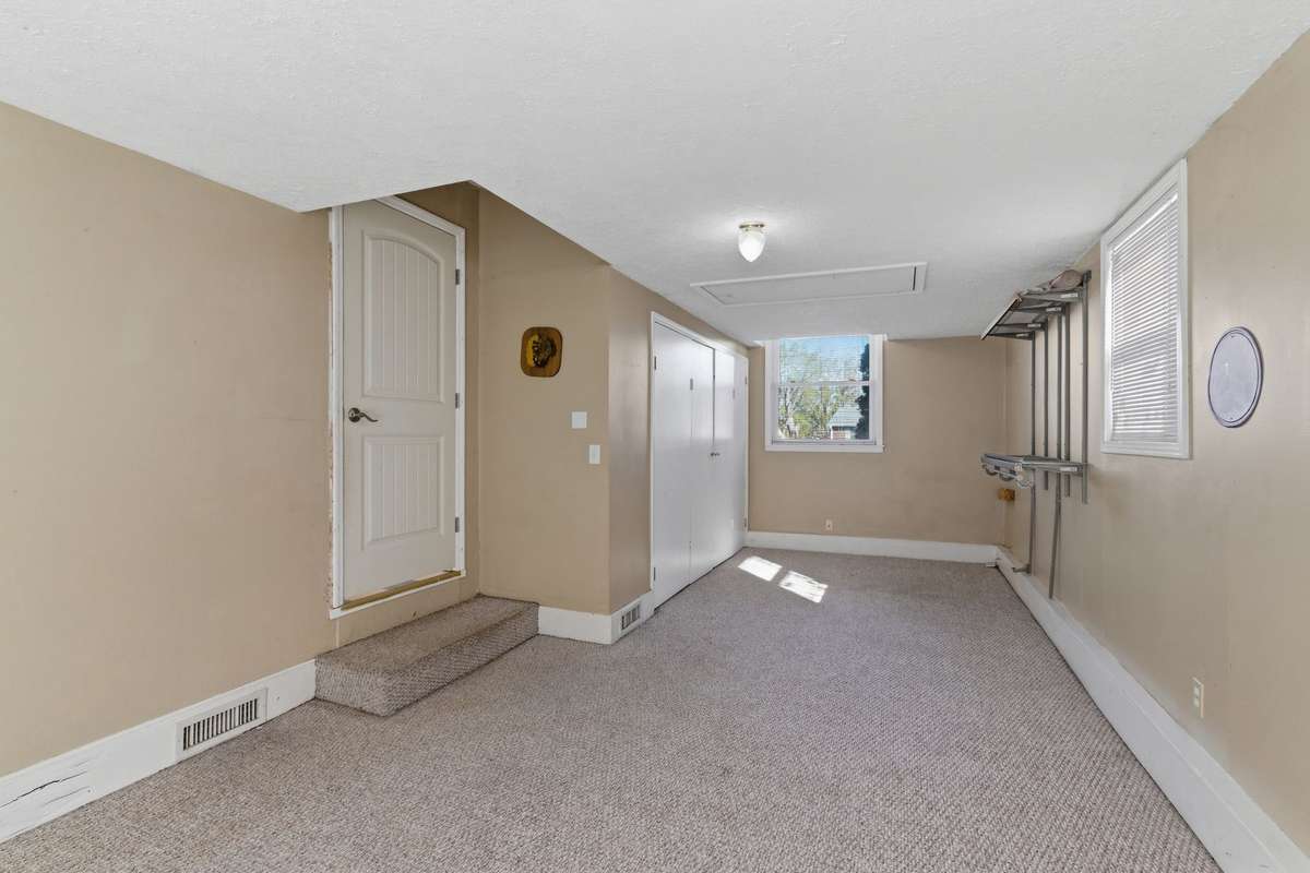 Another view of the Den (or Bonus Room).  The door to the left opens into the Kitchen and the bi-fold doors open into the Spacious Laundry Room.