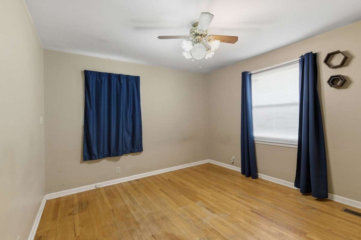 The Main Bedroom features original HARDWOOD FLOORS and TWO WINDOWS.
