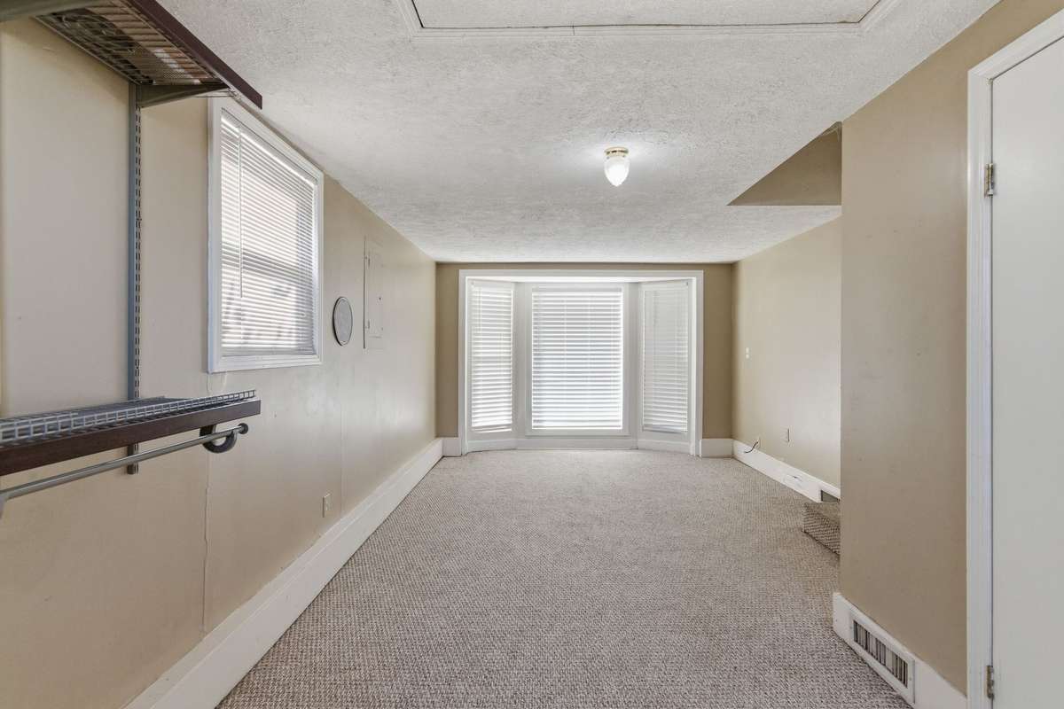The Step-Down Den (or Bonus Room) features a BAY WINDOW, with a total of 5 Windows in this Spacious room.  NOTE: THIS ROOM COULD MAKE A MAIN BEDROOM OR 4th BEDROOM, AS THE LAUNDRY ROOM (located at the rear) OFFERS ADDITIONAL CLOSET SPACE.
