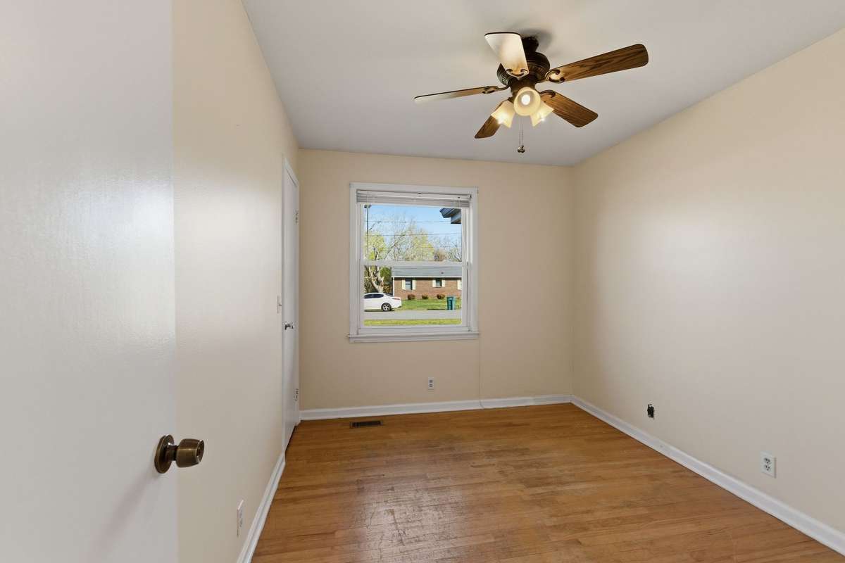 Another view of Bedroom #3 (12x9) which features a WINDOW and CEILING FAN.