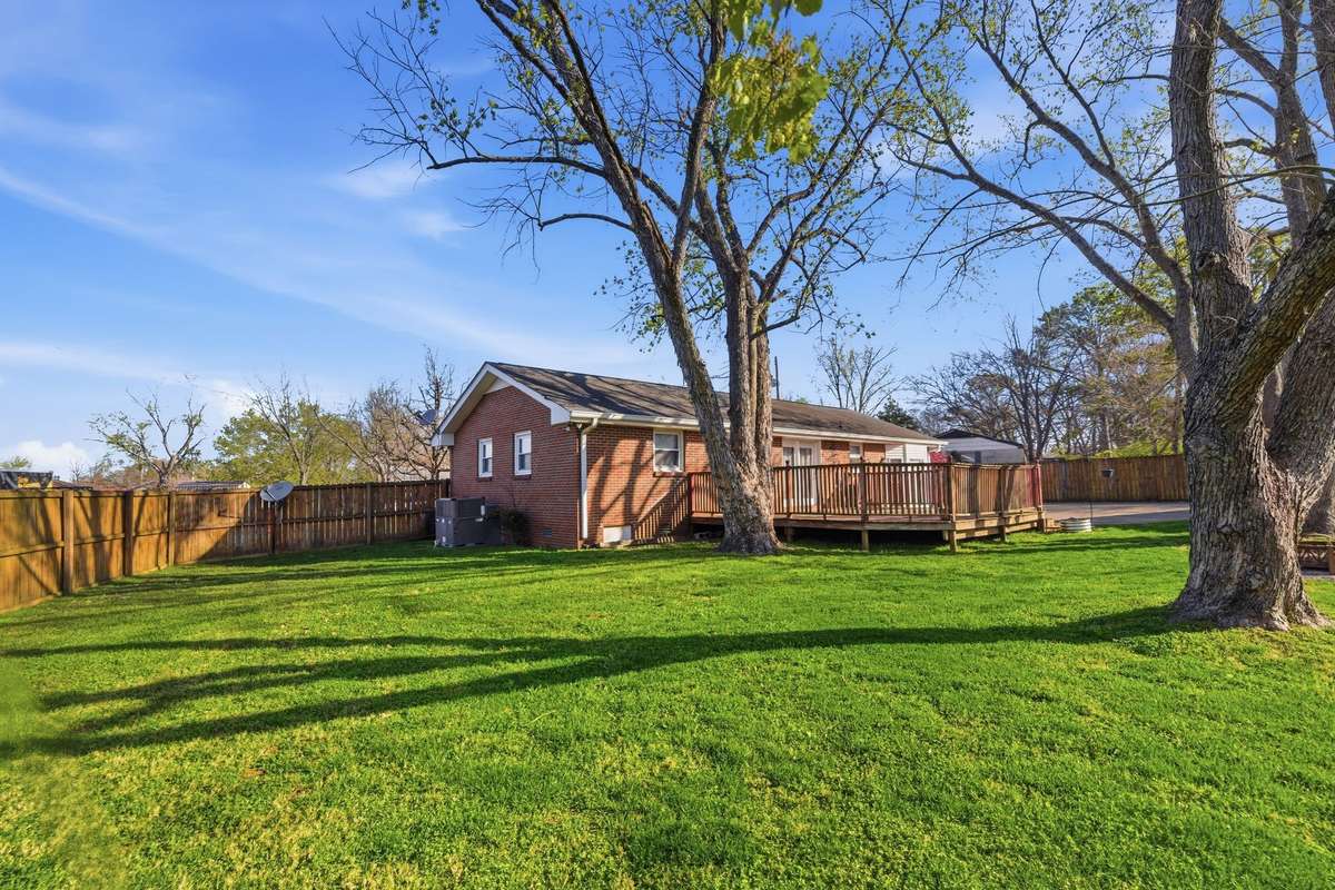 Notice the HUGE REAR DECK and PRIVACY FENCE from this photo.