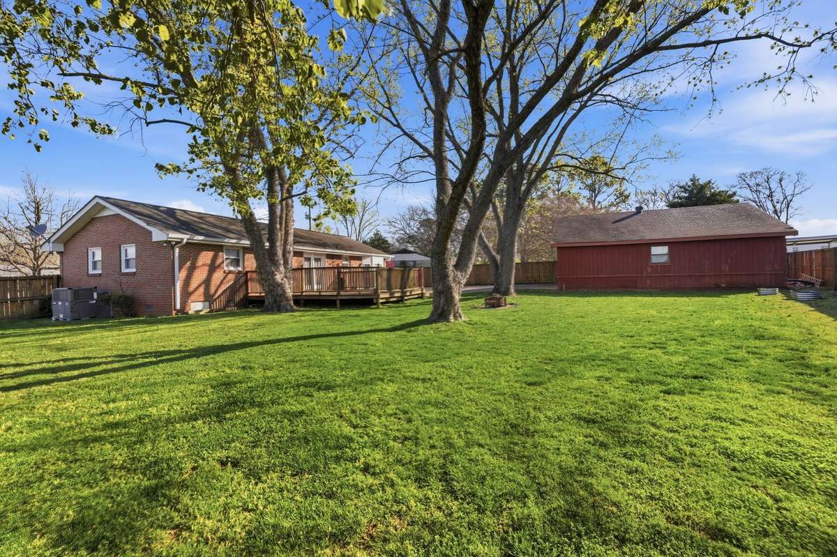 Another rear view of the Home and Detached Garage.  Keep in mind, for those with pets and/or children, this Home offers a Spacious "PRIVACY FENCED" Backyard.