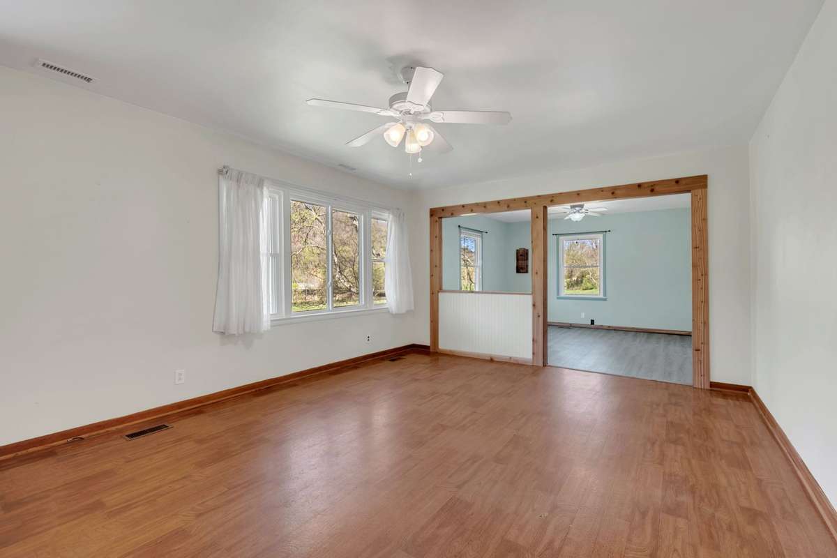The living room has a large picture window bringing in natural light.