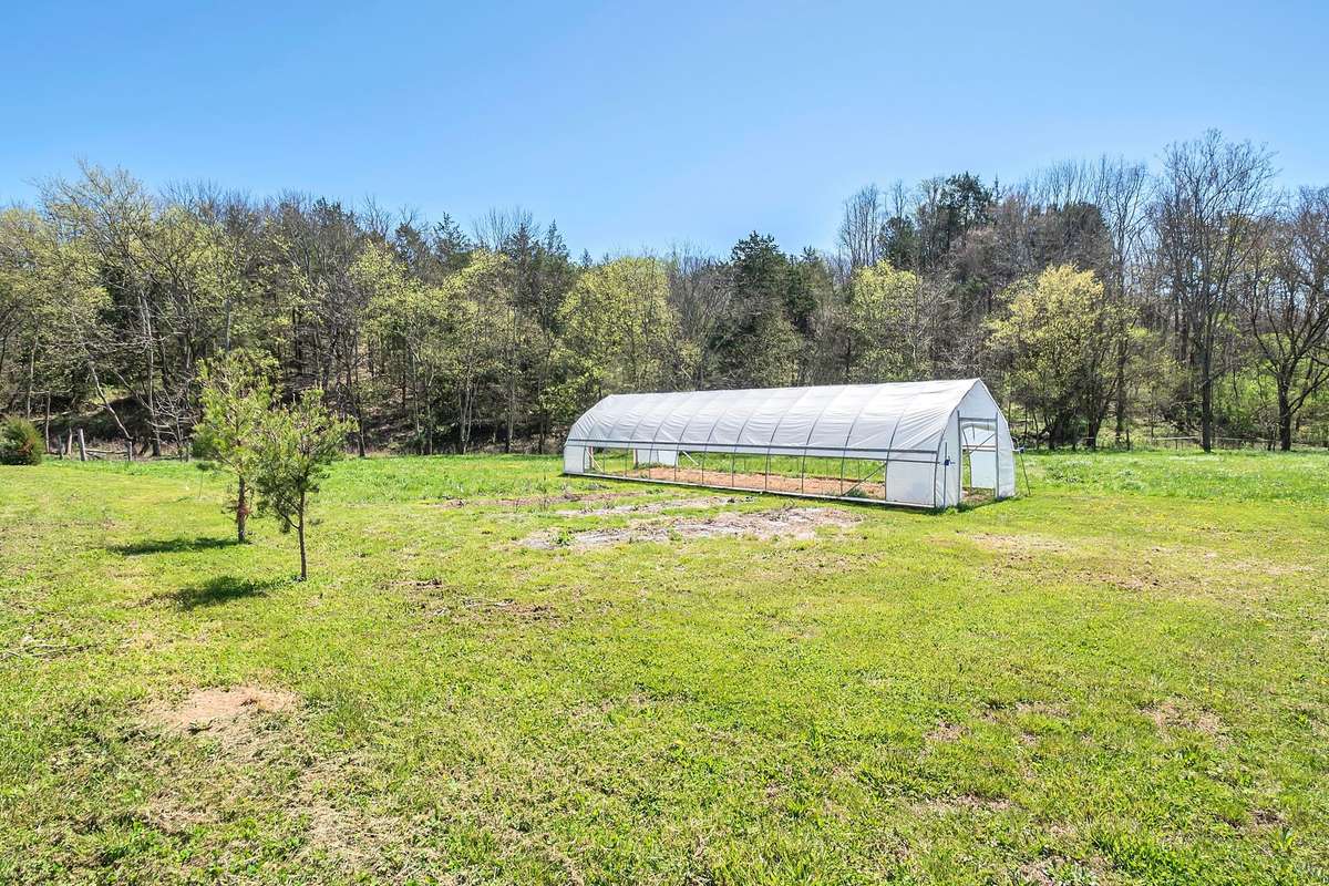 Off to the side of the house you'll be pleased to find multiple garden sites as well as a tunnel greenhouse