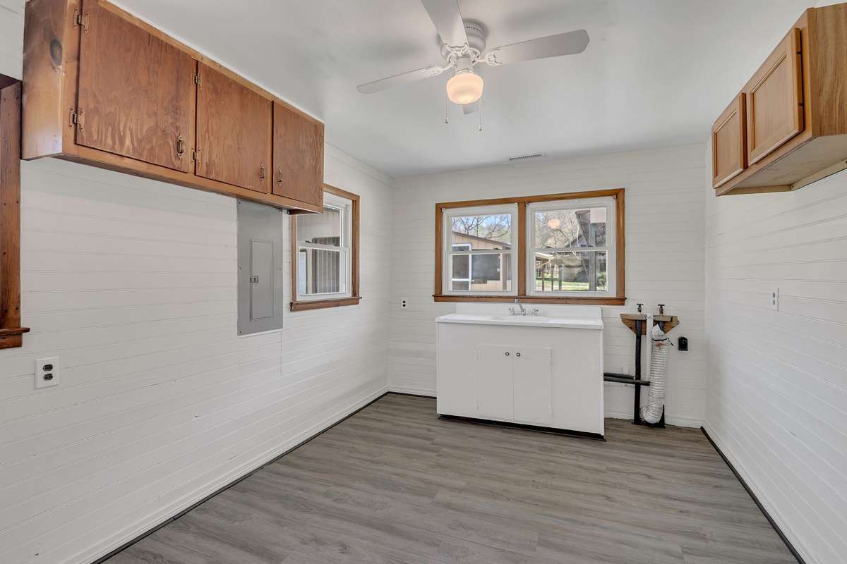 The mud room/laundry room features an amazing cast iron sink and plenty of cabinetry.