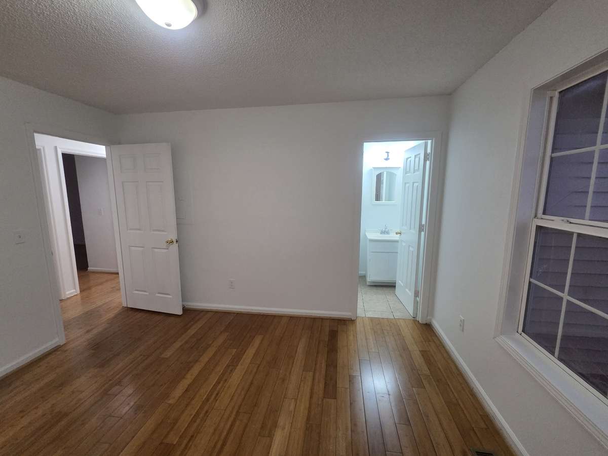 Primary bedroom with half bath