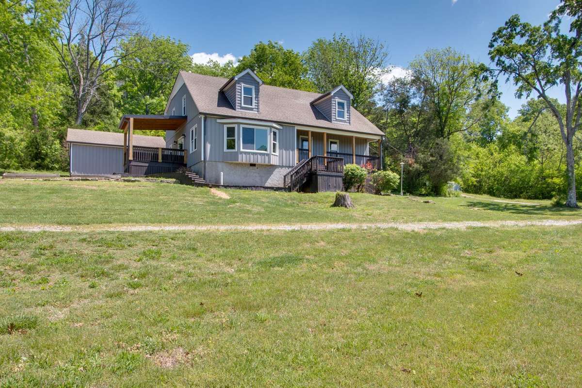 This home features a detached garage and a 4 stall barn which could also serve as a shop pictured to the right of home.